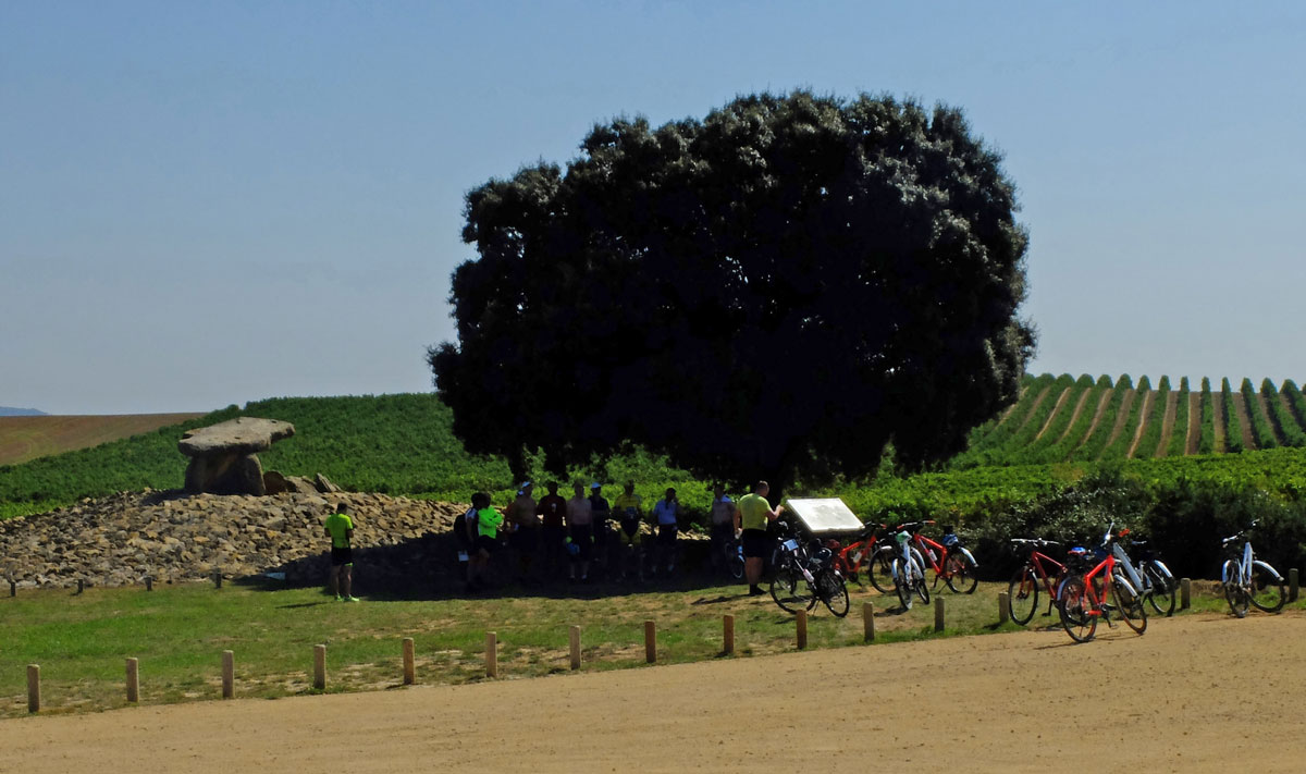 Dolmen-La-hechicera and group of cyclists